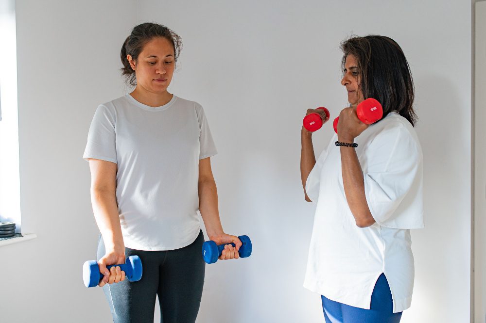 Clients doing bicep curls with Trainer Neil